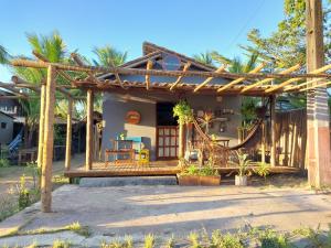 a house with a wooden pergola and a patio at Taipu In House in Marau