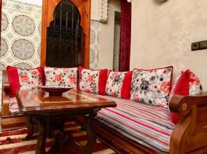a living room with a couch and a table at Dar El Jazouli in Marrakesh
