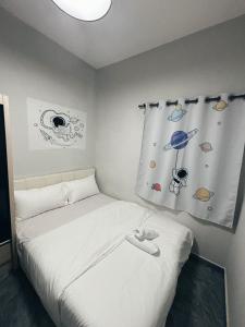 a bedroom with a bed with a window with planets at Room with Private Bathroom & Opposite KSL Mall in Johor Bahru