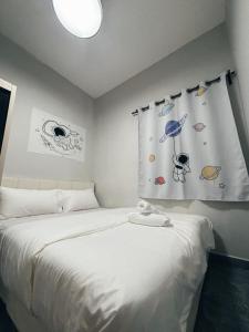 a bedroom with a white bed with planets on the wall at Room with Private Bathroom & Opposite KSL Mall in Johor Bahru