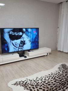 a living room with a large flat screen tv at Luxury ocean view in Busan