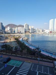 a view of a city with a river and buildings at Luxury ocean view in Busan