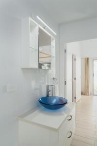 a bathroom with a blue bowl sink on a counter at Solwota Sands in Port Vila