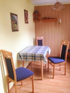 a table with two chairs and a blue and white table cloth at Bungalow mit Kamin in Ribnitz-Damgarten in Ribnitz-Damgarten