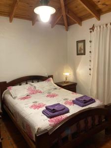 a bedroom with a bed with purple towels on it at Casa Nelly 2 in Playa Unión