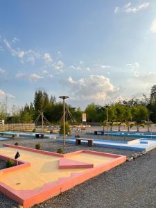 a park with a playground with tables and benches at Isbjorn chiangdao in Chiang Dao