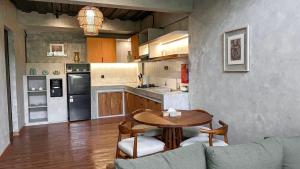 a kitchen with a table and chairs and a couch at Leafy Lofts Canggu in Canggu
