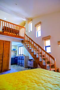 a bedroom with a staircase and a living room at La Ocotera hotel de montaña in La Esperanza