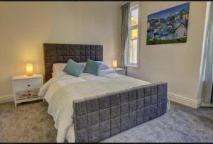 a bedroom with a large bed and a window at Kraken Cottage in Bridlington