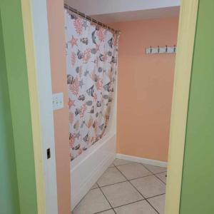 a bathroom with a shower curtain in a room at Champagne Isle Resort Unit 107 in Wildwood