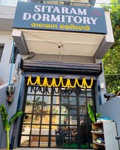 een winkel met een bord voor een restaurant bij SITARAM DORMITORY in Brahmapur