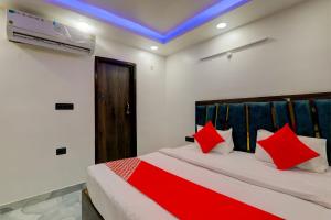 a bedroom with a bed with red pillows at OYO Flagship Hotel Love Inn in Lucknow