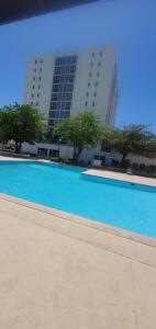 a large blue swimming pool in front of a building at Finest Accommodation Bay Front Apt # 609 in Greencastle