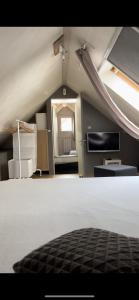 a attic room with a bed and a window at Lepadaloft in Villeneuve-Saint-Georges
