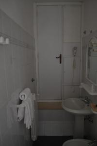 a bathroom with a sink and a shower with towels at Da Bianchina in Capanne