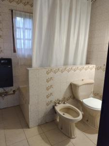 a bathroom with a toilet and a tub and a sink at Ananda in Ushuaia