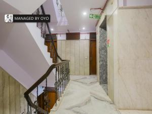 a hallway with a staircase in a building at Super OYO Chand Palace - Managed by Company in New Delhi