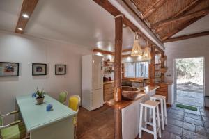 a kitchen with a refrigerator and a table in a room at Bolonia Beach Campus in Tarifa