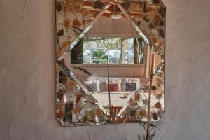 a mirror hanging on a wall with a window at Bolonia Beach Campus in Tarifa