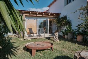 a wooden bench in the yard of a house at Bolonia Beach Campus in Tarifa