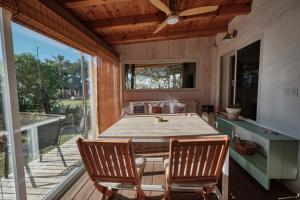 a screened in porch with a table and chairs at Bolonia Beach Campus in Tarifa