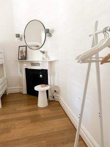 a white bathroom with a mirror and a stool at HAVEN: Stunning Unley *history*location*charm 3bd in Unley