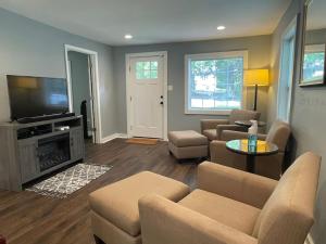 a living room with a couch and a tv at Cozy Home w/Deck & Fire Pit! in Greensboro