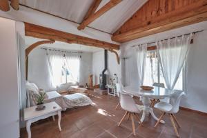 a living room with a table and chairs and a bed at Bolonia Beach Campus in Tarifa