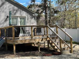 a wooden deck in front of a house at Cozy Home w/Deck & Fire Pit! in Greensboro