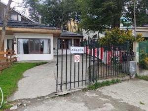 a black fence with a no parking sign in front of a house at Ananda in Ushuaia