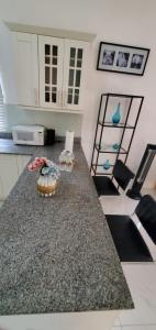 a kitchen with a counter top with flowers on it at Finest Accommodation Caymanas House # 16 in Caymanas
