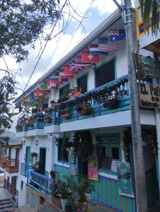 a building with colorful balconies and flags on it at El Patio de mi Casa Hotel Restaurante in Salento