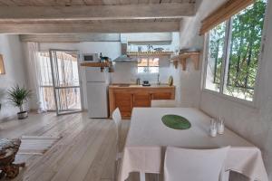 a kitchen and dining room with a table and chairs at Bolonia Beach Campus in Tarifa