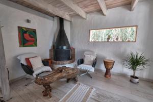 a living room with a table and a fireplace at Bolonia Beach Campus in Tarifa