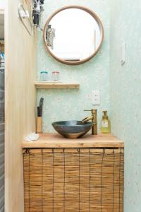 a bathroom with a bowl sink and a mirror at OneWorld Mibu壬生Luxury京町家 in Kyoto +132 photos