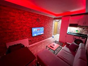 a living room with a couch and a brick wall at LEVENT PALACE OTEL in Istanbul