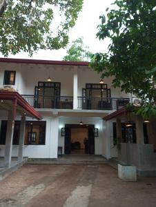 an exterior view of a building with a courtyard at Nade Villas Ahungalla in Ahungalla