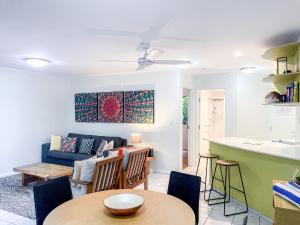 a living room with a couch and a table at Byron Getaway @ Eco Beach in Byron Bay