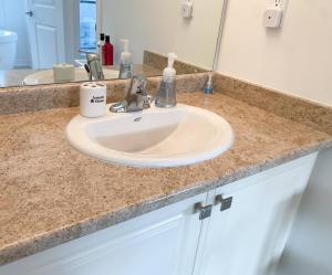 a bathroom counter with a sink and a mirror at Dockside Relaxing Private Bedroom,, in Whitby