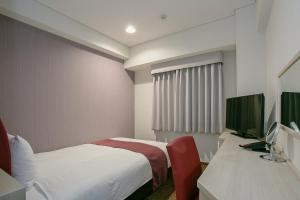 מיטה או מיטות בחדר ב-Mars Garden Hotel Hakata