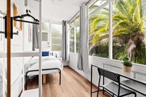 a bedroom with a desk and a window at Cozy Lindfield Stayz in Sydney