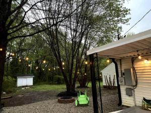 a yard with a tree and a house with lights at Relax in Privacy in 2BR Beauty w/ Fire Pit & Grill in Greensboro