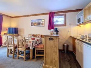 a kitchen with a table and a dining room at Grand appartement 3 pièces · Pied des pistes · Balcon · Wifi - FR-1-344-1205 in Les Bruyères