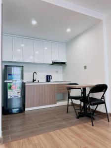 an empty kitchen with a table and a refrigerator at TINH ANH HOME in Hanoi