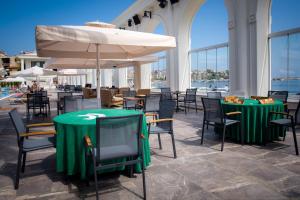 a restaurant with tables and chairs and an umbrella at Northdoor Hotel in Amasra