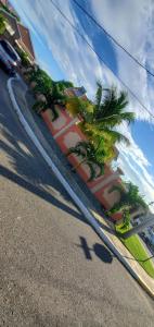 a street with palm trees in front of a building at Finest Accommodation Caribbean Estate Lot 78 in Portmore