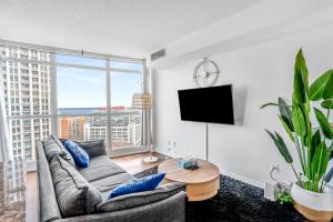 a living room with a couch and a large window at Toronto downtown Fort York suites 1BDRM with parking in Toronto