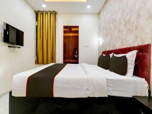 a bedroom with a large bed and a television at Hotel Iconic Stay in Indore