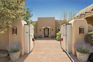 a courtyard of a house with a building at Villa Namaste-Mountain View Home in Santa Fe