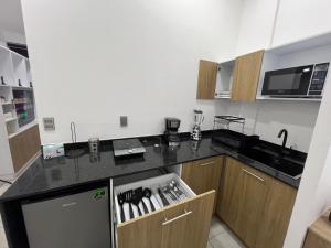 a kitchen with a counter top with a refrigerator at Loft Jardines in Tuxtla Gutiérrez